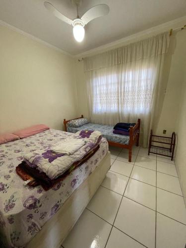 a bedroom with two beds and a window at Hostel e Pousada Vó Lili in Joinville