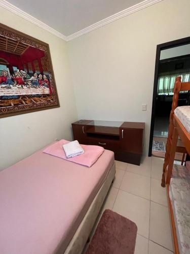 a room with two beds and a dresser in it at Hostel e Pousada Vó Lili in Joinville