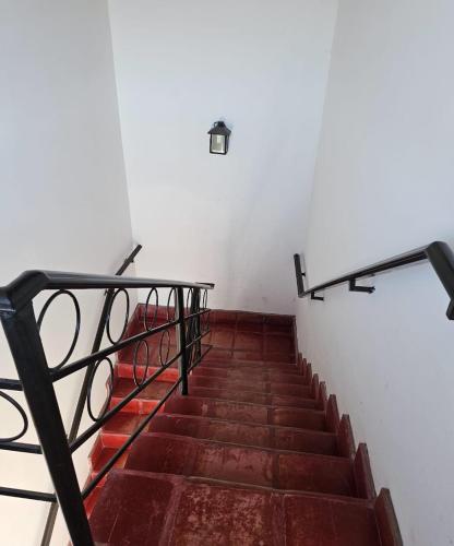 a staircase with a metal railing and a stair case at Cafayate Deptos in Cafayate