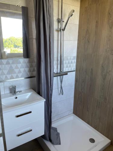 a bathroom with a shower and a sink and a sink at Pensjonat Anna in Osłonino