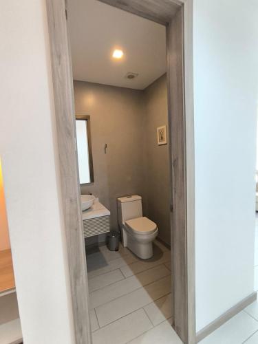 a bathroom with a toilet and a sink at Panoramic Terrace ESSENCE Luxury Suite in Carolina Park in Quito