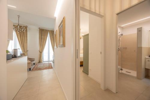 a hallway of a home with a bathroom and a kitchen at Corte Realdi Suites Arena in Verona