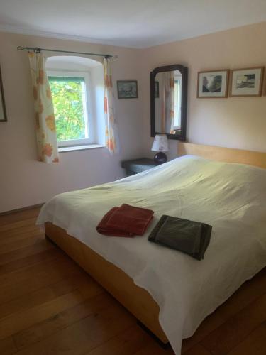 a bedroom with a large bed with two towels on it at Appartement près de DOLE in Menotey
