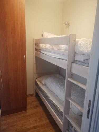 a room with a bunk bed with white towels at Korshamn in Lyngdal