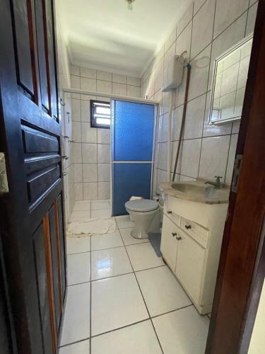 a small bathroom with a toilet and a sink at Hostel e Pousada Vó Lili in Joinville
