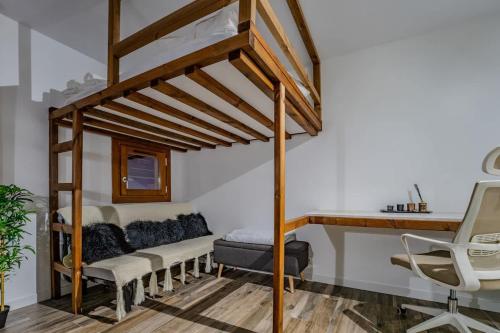 a bedroom with a loft bed with a desk and a chair at Ski in-out, Heart Val Thorens, Charming Studio, Wifi 141 in Val Thorens