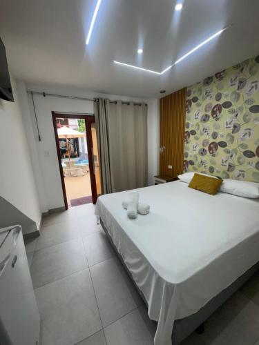 a bedroom with a large white bed in a room at Hotel MELAO in Pedernales