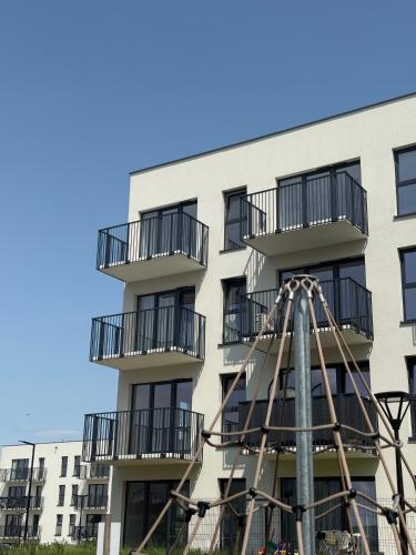 a building with a ferris wheel in front of it at CASHMERE Apartment - Airport Katowice-Pyrzowice in Siewierz