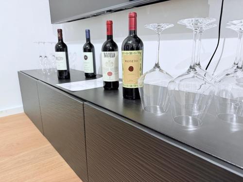 a counter with wine bottles and glasses on it at designAparts - I - Penthouse mit Dachterrasse in Bayreuth