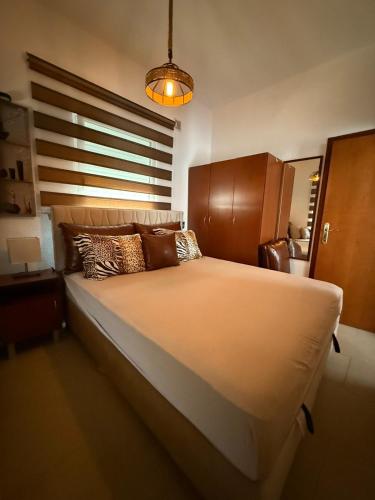 a bedroom with a large bed with a large window at Lux Apartman David Dobra voda in Bar