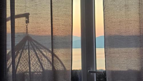 a shadow of a tower is seen through a window at LAKE Dream 1 in Star Dojran