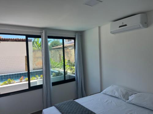 Ένα ή περισσότερα κρεβάτια σε δωμάτιο στο Flat Beira Mar Maracaípe- Porto de Galinhas