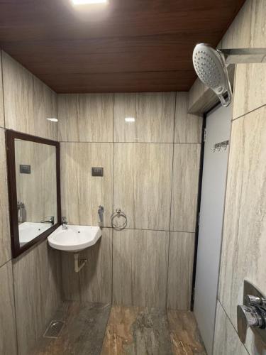 a bathroom with a sink and a mirror at Zaid & Nida House in Panchgani