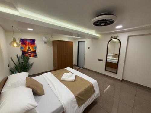 a bedroom with a large bed and a mirror at Zaid & Nida House in Panchgani