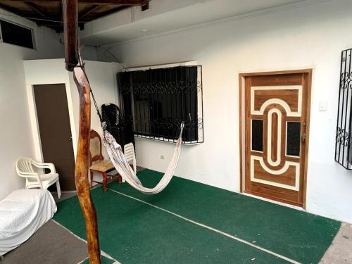 a room with a hammock in front of a door at My Place in paradise II in San Cristobal