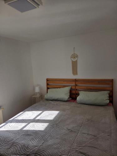 a bedroom with a large bed with two pillows at Ferienwohnung bei Meißen 