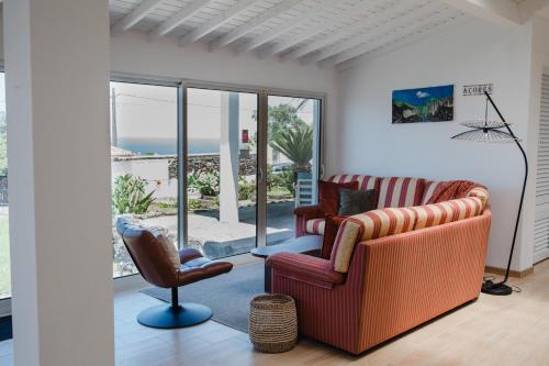 a living room with a couch and a chair at Ocean View Villa Retreat Quinta do Sol in Rabo de Peixe