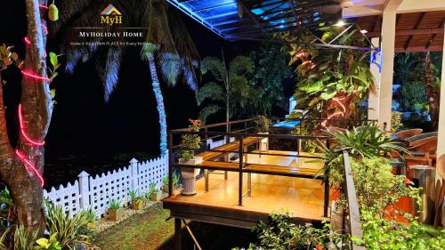 a house with a wooden deck with plants on it at MYH - Lake Front Pvt Villa with Staff and Includes FREE Breakfast of your choice in Bandaragama