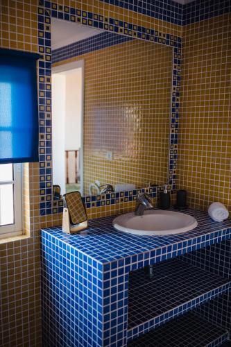a bathroom with a sink with a mirror and a tub at Ocean View Villa Retreat Quinta do Sol in Rabo de Peixe