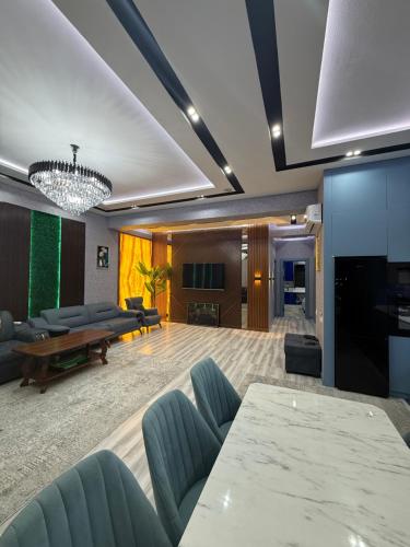 a living room with a couch and a table at Gardens resident Tashkent city in Tashkent
