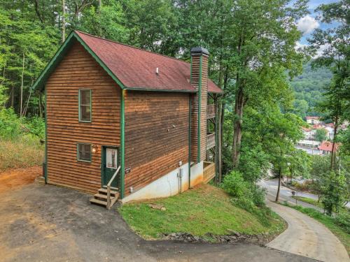 a small house with a green door next to a road at New Alpenrosen Haus-Arcade Hot Tub Sauna Views in Helen
