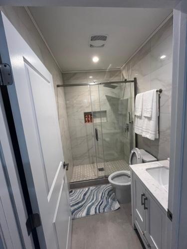 a bathroom with a shower and a toilet and a sink at Guest House in Torrance
