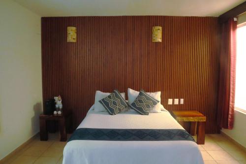 Ένα ή περισσότερα κρεβάτια σε δωμάτιο στο Quinta Bella Huatulco
