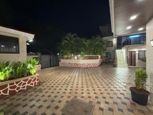 a courtyard of a house at night with plants at Zaid & Nida House in Panchgani