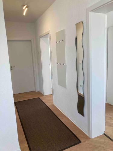 a room with two mirrors on a wall at Monteurwohnung Ferienwohnung mit Terrasse in Dernbach