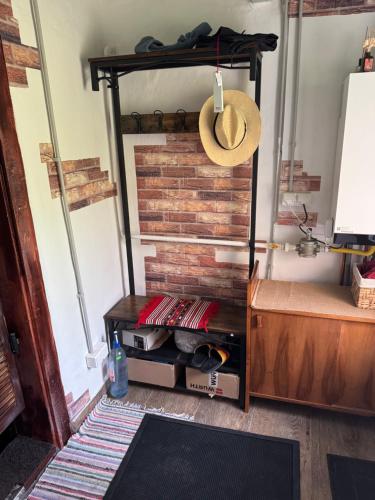 a hat is hanging on a shelf in a room at Casuta lu Carmen in Săbed