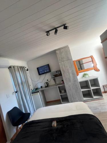 Un dormitorio con una cama y un escritorio con televisión. en Oriebruggie Accommodation, en Calvinia