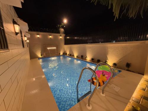 a swimming pool at night with a slide in it at Zaid & Nida House in Panchgani
