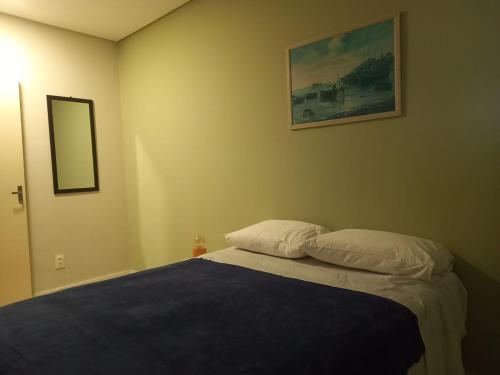 a bedroom with a bed with a blue blanket at Historico Edf Oceania in Boa Viagem in Recife