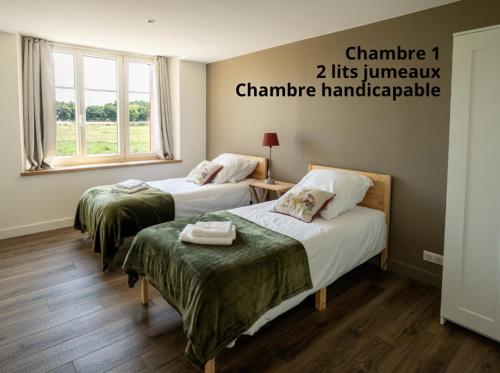 a room with two beds and a window at Proche Puy duFou - Les Buardieres in Saint-Pierre-des-Échaubrognes