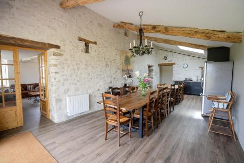 a kitchen and dining room with a table and chairs at Proche Puy duFou - Les Buardieres in Saint-Pierre-des-Échaubrognes