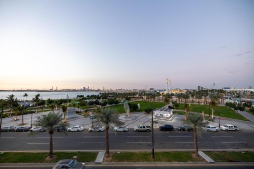 a parking lot with palm trees and a harbor at nasim aizraq hotel فندق نسيم ازرق in Jeddah