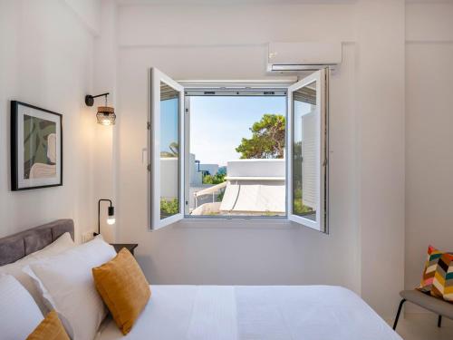 a bedroom with a bed and a window at Casa De Tamara Paros in Kampos Paros