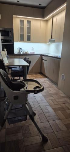 a kitchen with a table and a chair in a room at Olesjas Apartamenti 