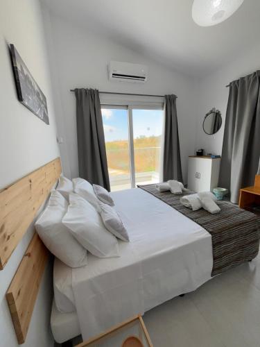 a bedroom with a large bed with a large window at Villa Phos in Kathikas