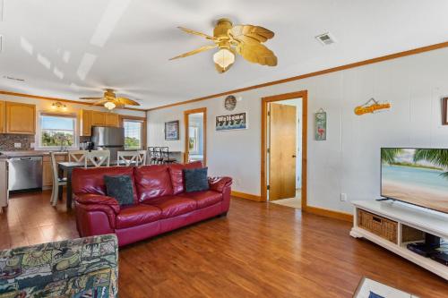 a living room with a couch and a tv at 6153 - Seascape in Nags Head