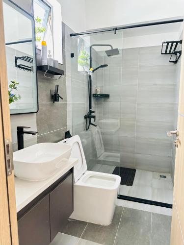 a bathroom with a sink and a toilet and a shower at Urban Stays-Two bedroom Near JKIA Airport in Nairobi