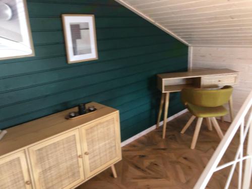 a room with a desk and a chair in a house at Przylesie Domki in Wysoczany