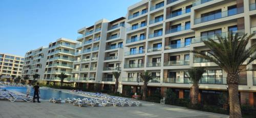 a large building with a pool in front of it at SEA BREEZE Baku-FH in Baku