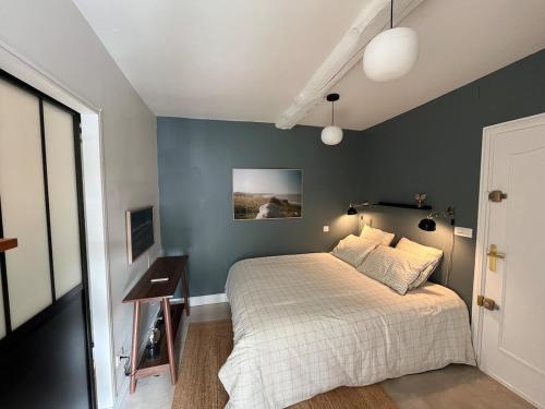 a bedroom with a bed and a nightstand and a bed sidx sidx sidx sidx at Veules-les-Roses Studio in Veules-les-Roses