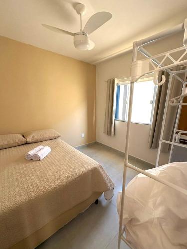 a bedroom with a bed and a bunk bed at Oasis das Dunas in Cabo Frio