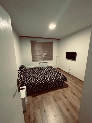a bedroom with a bed and a flat screen tv at CityOasis Tuzla in Tuzla