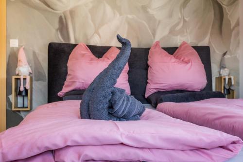 a stuffed animal is laying on a bed at Gite des cigognes in Kintzheim