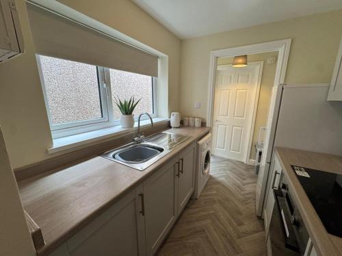 a kitchen with a sink and a window at Birks Terrace - 2 Bedroom - Sleeps 4 in Cleator Moor