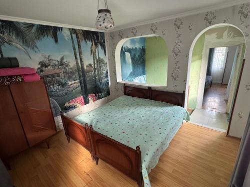 a bedroom with a bed in a room at Borjomi Cozy Cottage in Borjomi