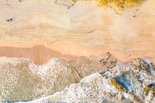 an overhead view of a beach with waves and rocks at Dreamcatcher Luxury in Santa Teresa Beach